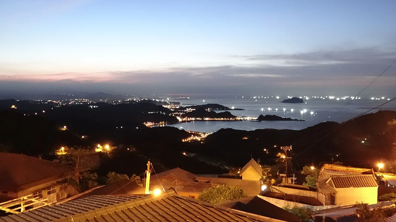 Night view from Jiufen’s hillside toward the coast
