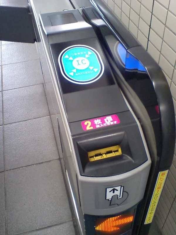 Fare gate with IC reader and paper-ticket slot